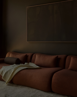 Q11 sofa styled in a moody, low-lit interior